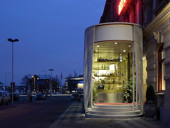 A hotel in Sweden gets a pavilion draped with perforated aluminium