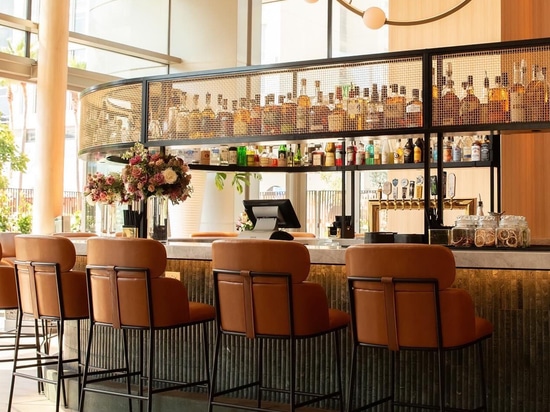 Industrial-chic bar environment with wire mesh textures and contemporary seating at Ace Porter
