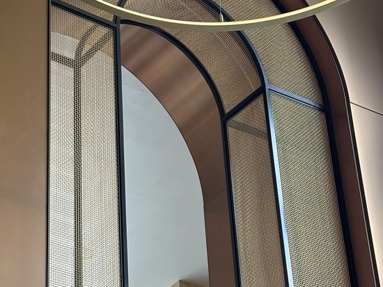 Detail of the arch way framed in bronze decorative woven wire mesh at Omni San Diego Hotel