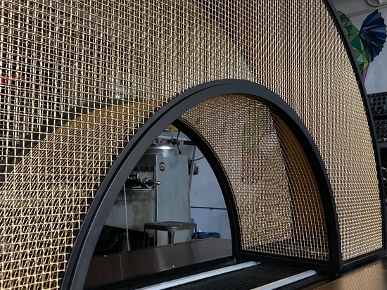 Curved bronze mesh archway designed and fabricated by Desposito Designs for the Ace Porter bar in the Omni San Diego