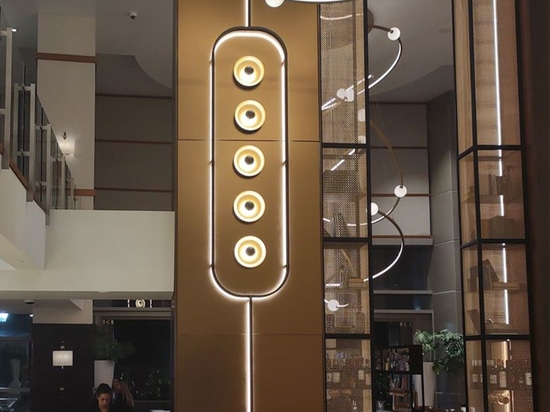 Bronze arch way framed in decorative woven wire mesh at Omni San Diego Hotel