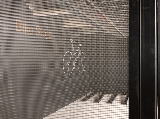The secure bike storage area uses durable LPZ-71 woven wire mesh panels to provide visibility, ventilation, and long‑lasting protection.