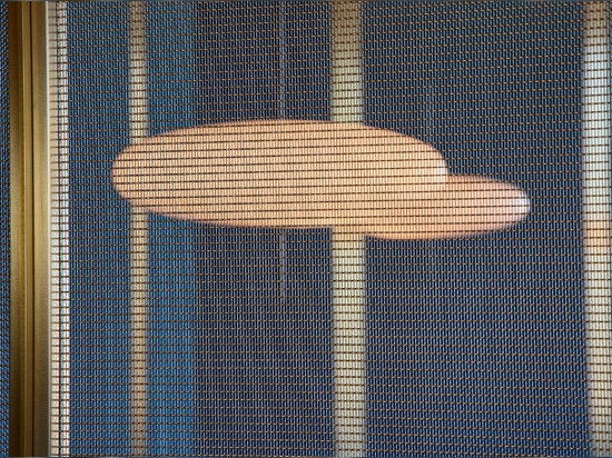 Decorative woven wire mesh IPZ-25 installed in corporate interior design as a space divider.