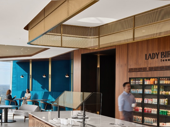 Decorative woven wire mesh installed in corporate interior design as a gantry over a bar