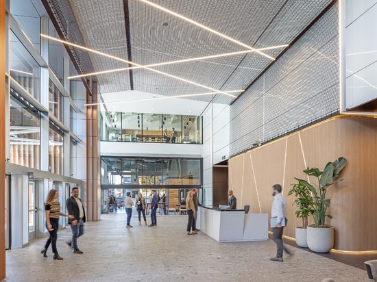 Dune 40100 flexible wire mesh continues the textured design element  from the exterior facade into the welcoming space of the lobby