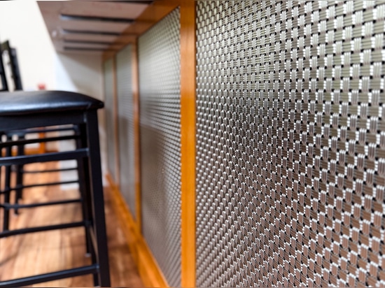Discover how Banker Wire's M33-2 woven wire mesh adds texture, depth, and sophistication to this custom home bar remodel, creating a striking architectural focal point.