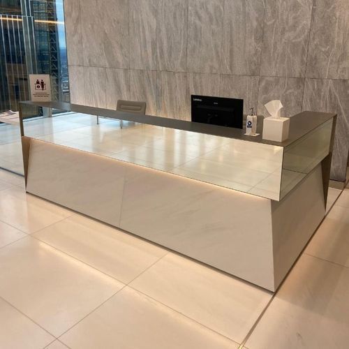 Balcão de recepção em L - Specialist Joinery Group - modular / em vidro / com iluminação