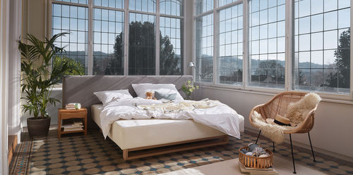 Cama de casal - TITLIS - HÜSLER NEST - contemporânea / estofada / com cabeceira
