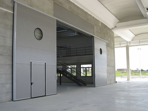 Porta industrial seccionada - ALLMURA - MURA - de correr / metálica / para edifício de uso público