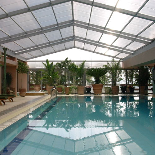Cobertura de piscina alta - COSPICON  SA - de correr / fixa / em alumínio